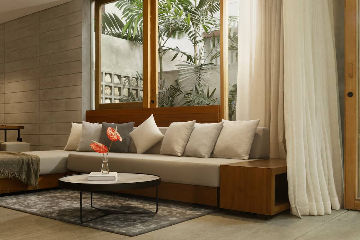 A cozy living room equipped with a smart TV and a Marshall speaker for entertainment