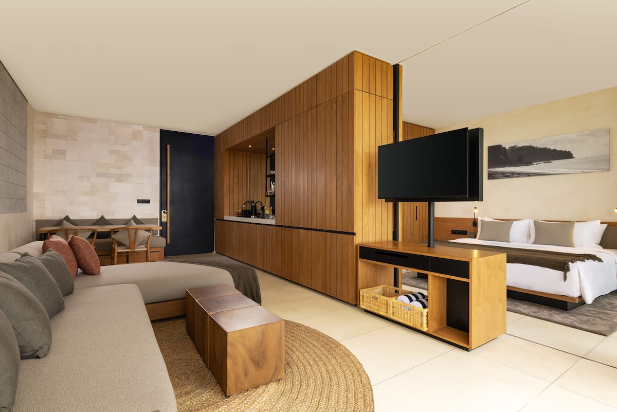 A cozy living room equipped with a smart TV and a Marshall speaker for entertainment