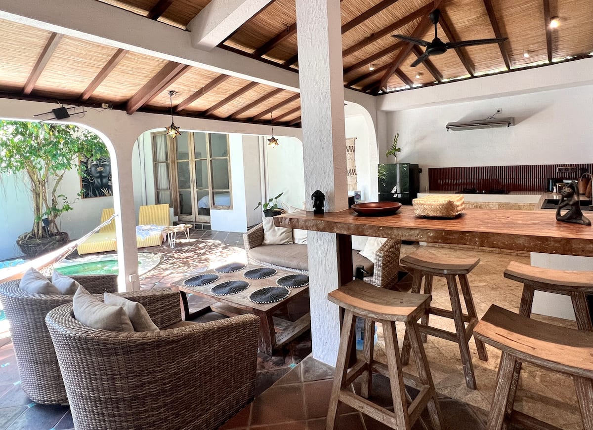 Open living space with kitchen, lounge and direct access to your private pool.