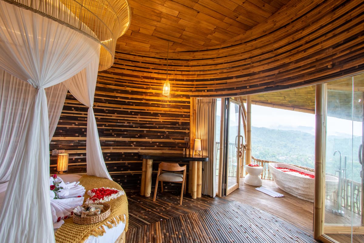 Middle Bedroom - Equipped with a round bed, desk, wardrobe, standing mirror and its own Balcony with Bathtub.