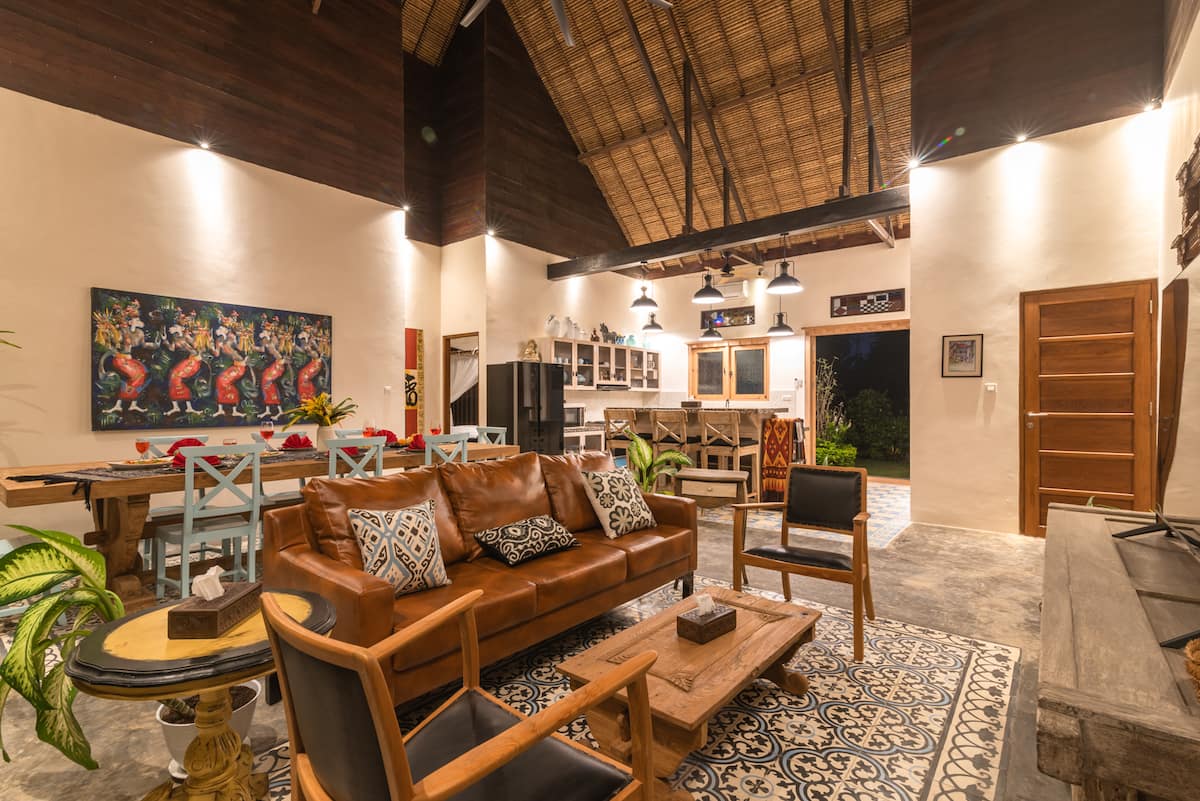 Open living room, dining room, and kitchen, soaring natural thatch ceiling (cool & dry).